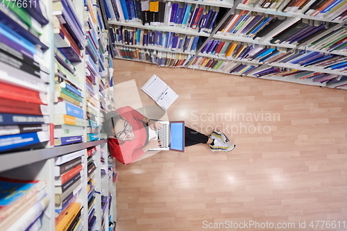 Image of the students uses a notebook, laptop and a school library