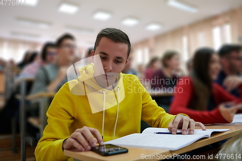 Image of Student using a calculator while calculating in a math class