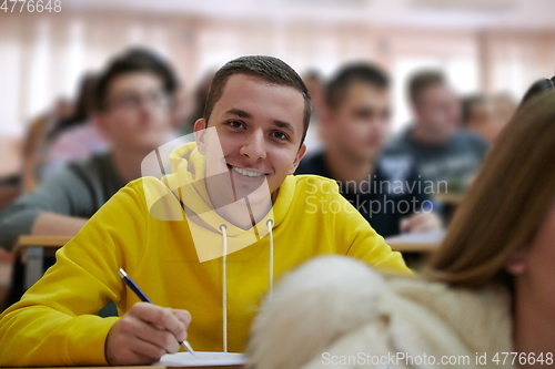 Image of student taking notes while studying in high school