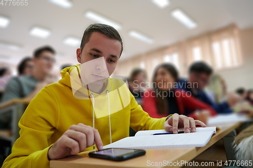 Image of Student using a calculator while calculating in a math class