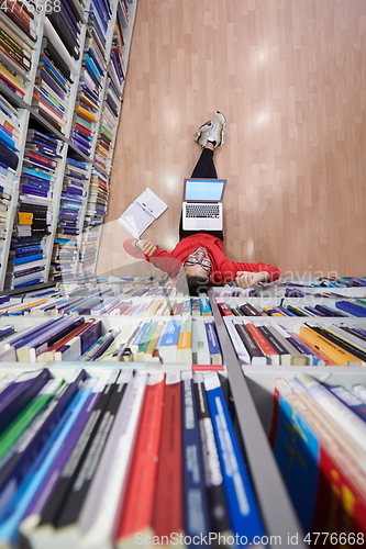 Image of the students uses a notebook, laptop and a school library