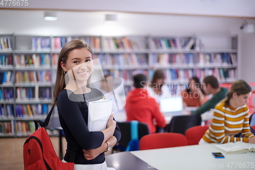 Image of the student uses a notebook and a school library