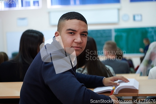 Image of student taking notes while studying in high school