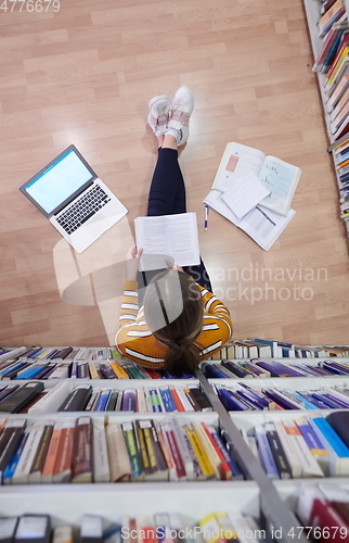 Image of the student uses a notebook and a school library