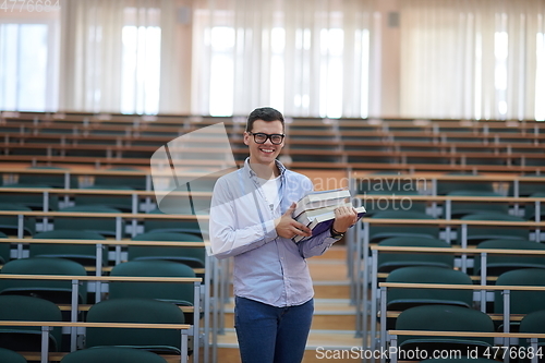 Image of man with book in calssroom