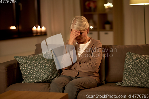 Image of unhappy senior woman suffering from headache