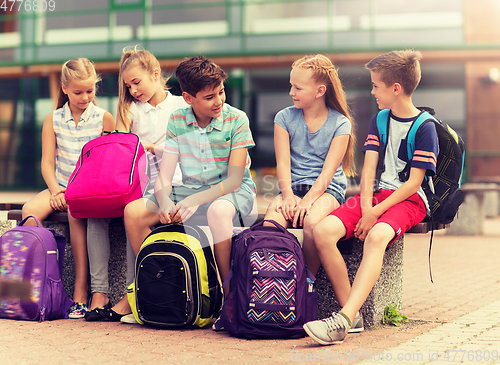 Image of group of happy elementary school students talking