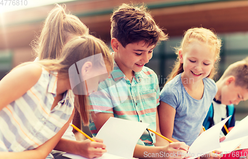 Image of group of happy elementary school students outdoors