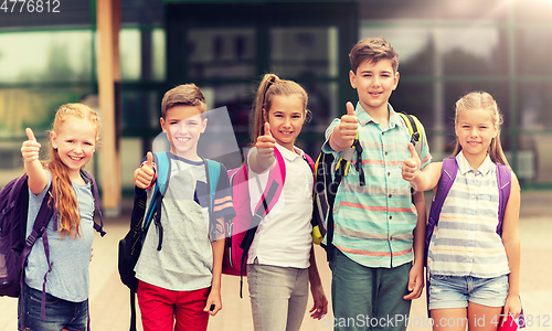 Image of happy elementary school students showing thumbs up