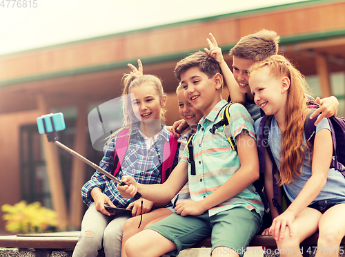 Image of happy elementary school students taking selfie