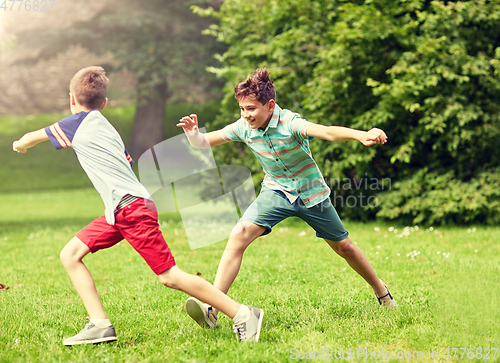 Image of happy kids running and playing game outdoors