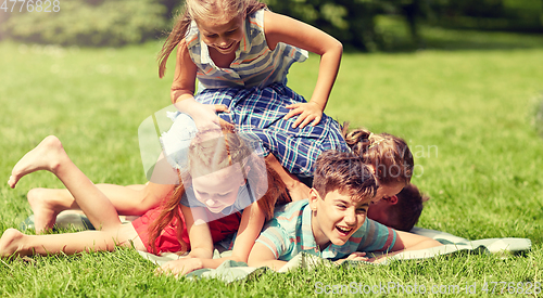 Image of happy kids playing and having fun in summer park
