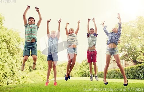 Image of happy kids jumping and having fun in summer park