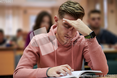 Image of the student has a headache in class