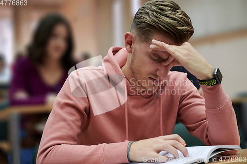 Image of the student has a headache in class