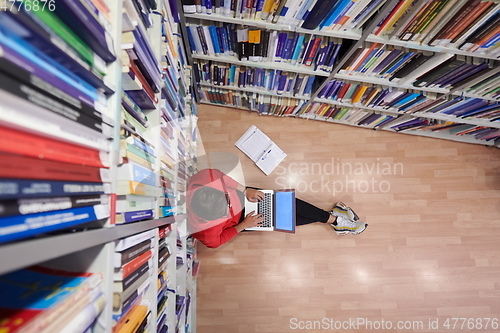 Image of the students uses a notebook, laptop and a school library