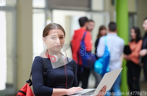 Image of famel student with modern technology in school