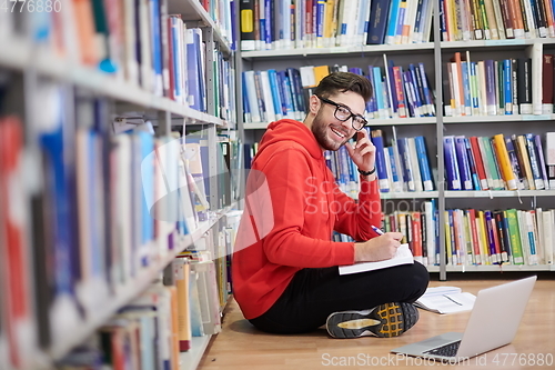 Image of the students uses a notebook, laptop and a school library