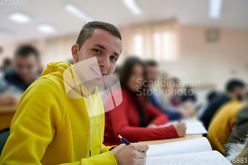 Image of student taking notes while studying in high school