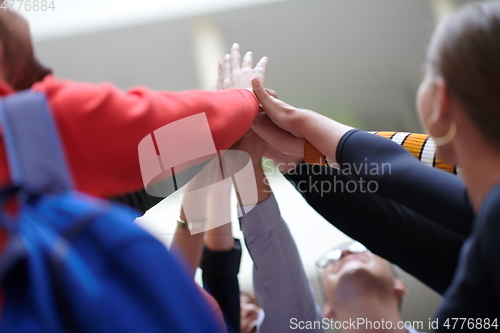 Image of students together in problem, arm in the air