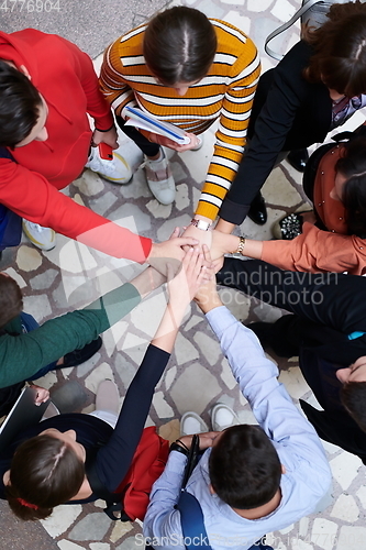 Image of group of happy young people showing their unity.