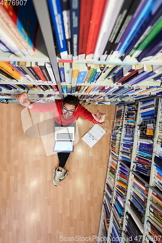 Image of the students uses a notebook, laptop and a school library