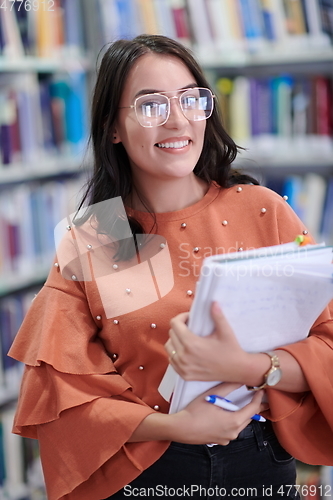 Image of the student uses a notebook and a school library