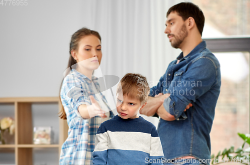 Image of unhappy little boy over arguing parents at home