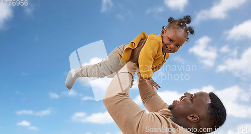 Image of happy african american father with baby over sky