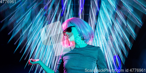 Image of woman in wig and sunglasses dancing at nightclub