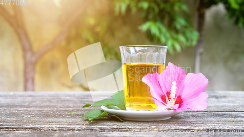 Image of Mallow tea with blossom on old wooden background