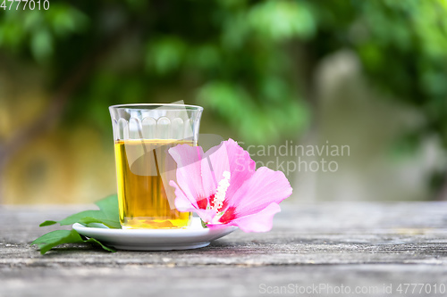 Image of Mallow tea with blossom on old wooden background