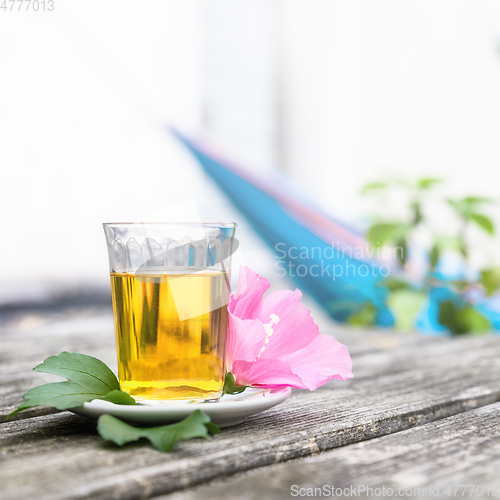 Image of Mallow tea with blossom on old wooden background