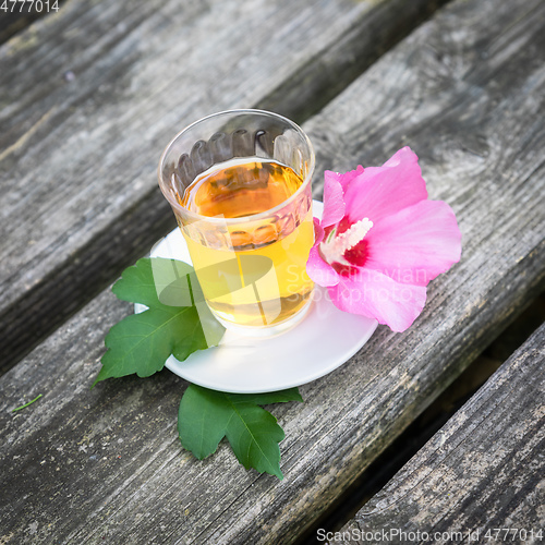 Image of Mallow tea with blossom on old wooden background