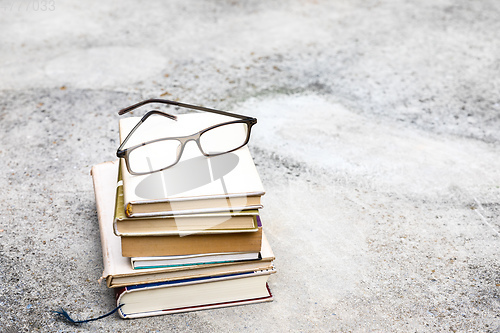 Image of books and reading glasses