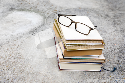 Image of books and reading glasses