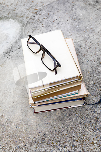 Image of books and reading glasses