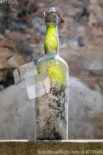 Image of dirty old wine bottle