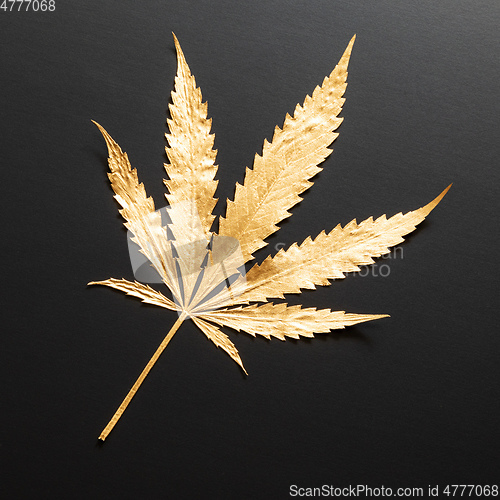 Image of golden Cannabis leaf isolated on black