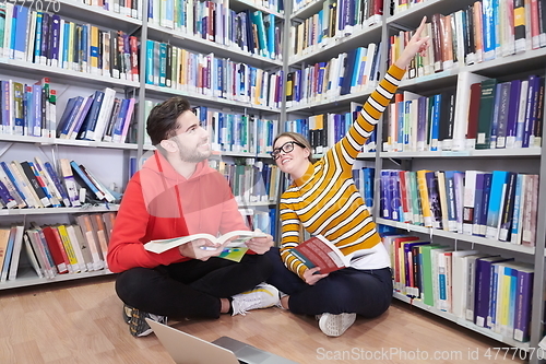 Image of the students uses a notebook, laptop and a school library