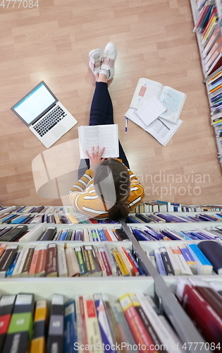 Image of the student uses a notebook and a school library