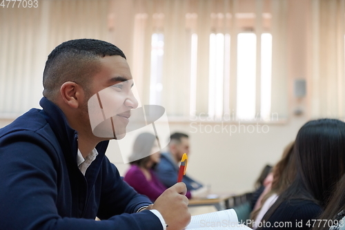 Image of student taking notes while studying in high school