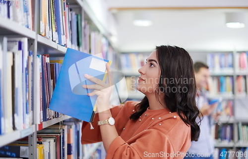 Image of the student uses a notebook and a school library