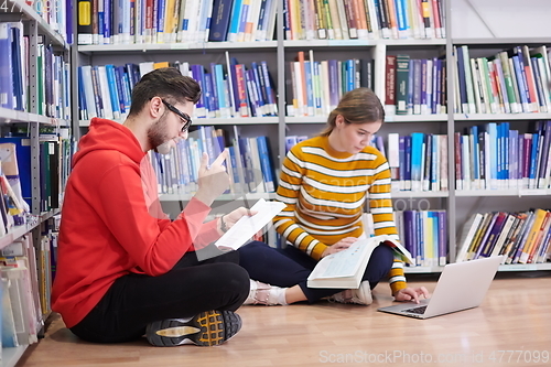 Image of the students uses a notebook, laptop and a school library