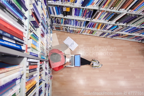 Image of the students uses a notebook, laptop and a school library