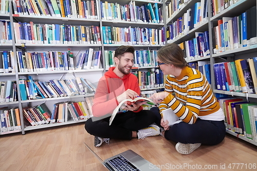 Image of the students uses a notebook, laptop and a school library