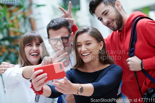 Image of Group of multiethnic teenagers taking a selfie in school