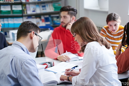 Image of students group working on school project together on tablet computer at modern university