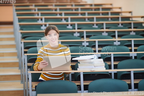 Image of student taking notes for school class