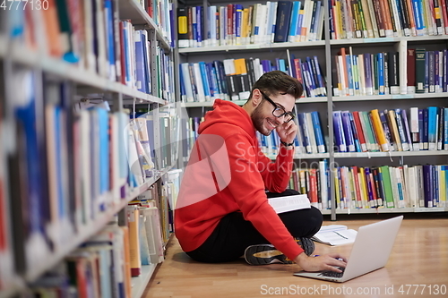 Image of the students uses a notebook, laptop and a school library